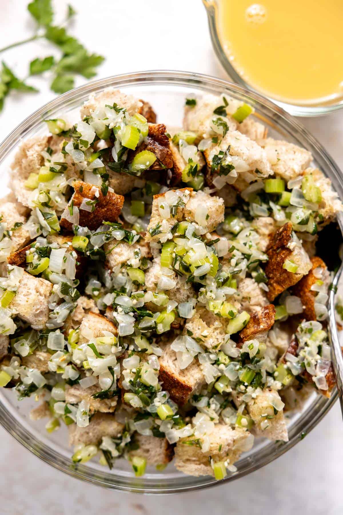 stale sourdough bread mixed with sauteed veggies in a bowl.