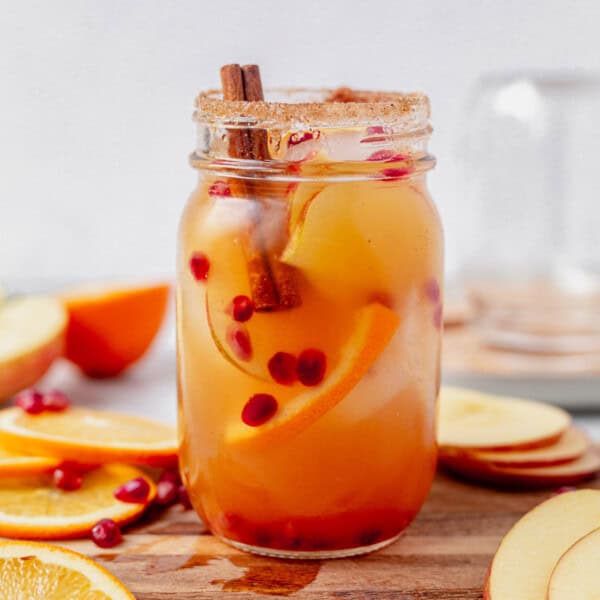 apple cider sangria with cinnamon sugar rim in a mason jar.