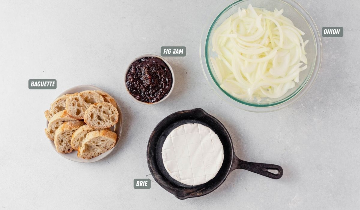 ingredients for baked brie with fig jam measured out on a table with labels