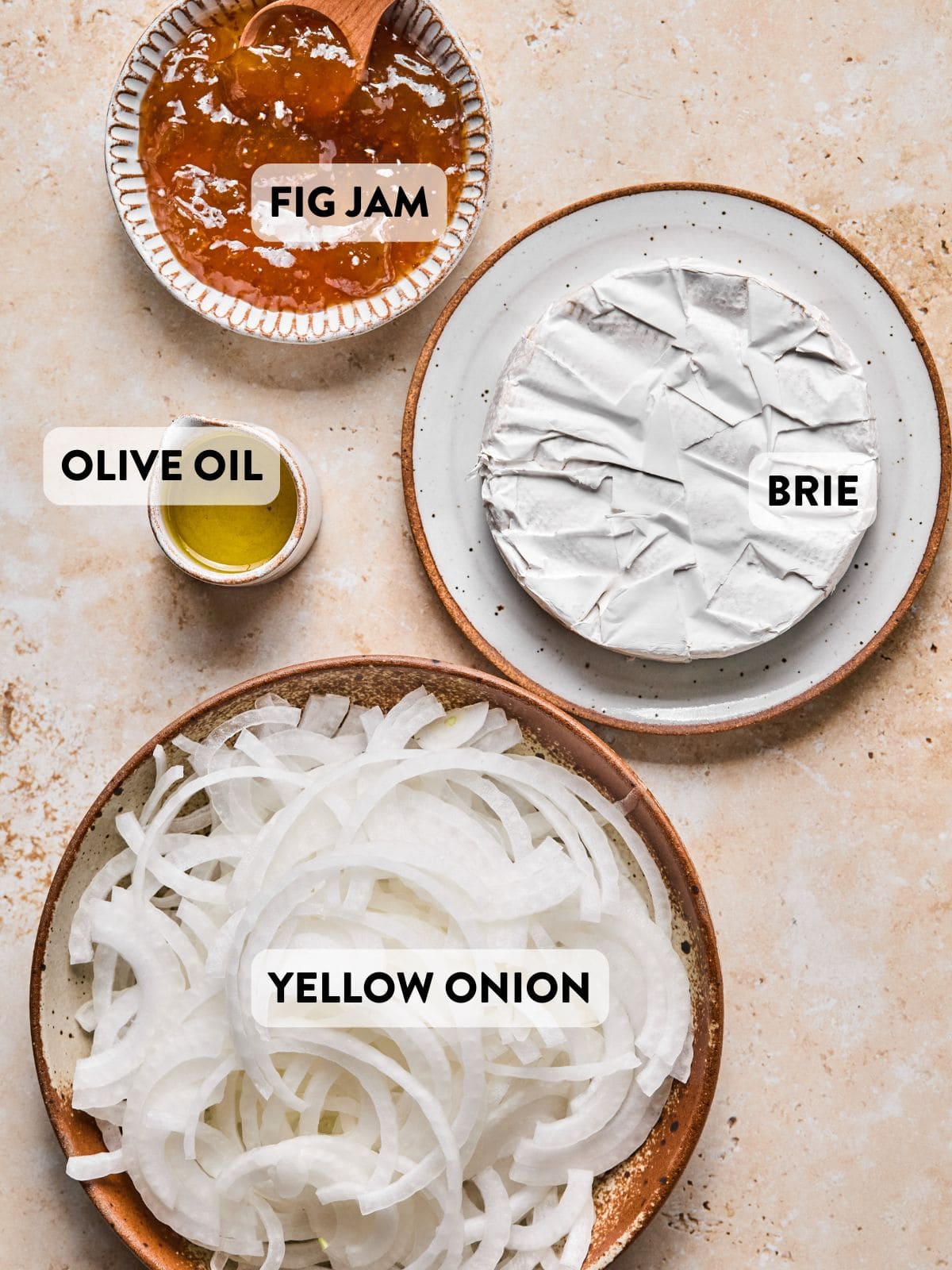 ingredients for caramelized onion baked brie laid out on a counter