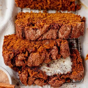 three slices of cinnamon pumpkin bread on a serving platter.