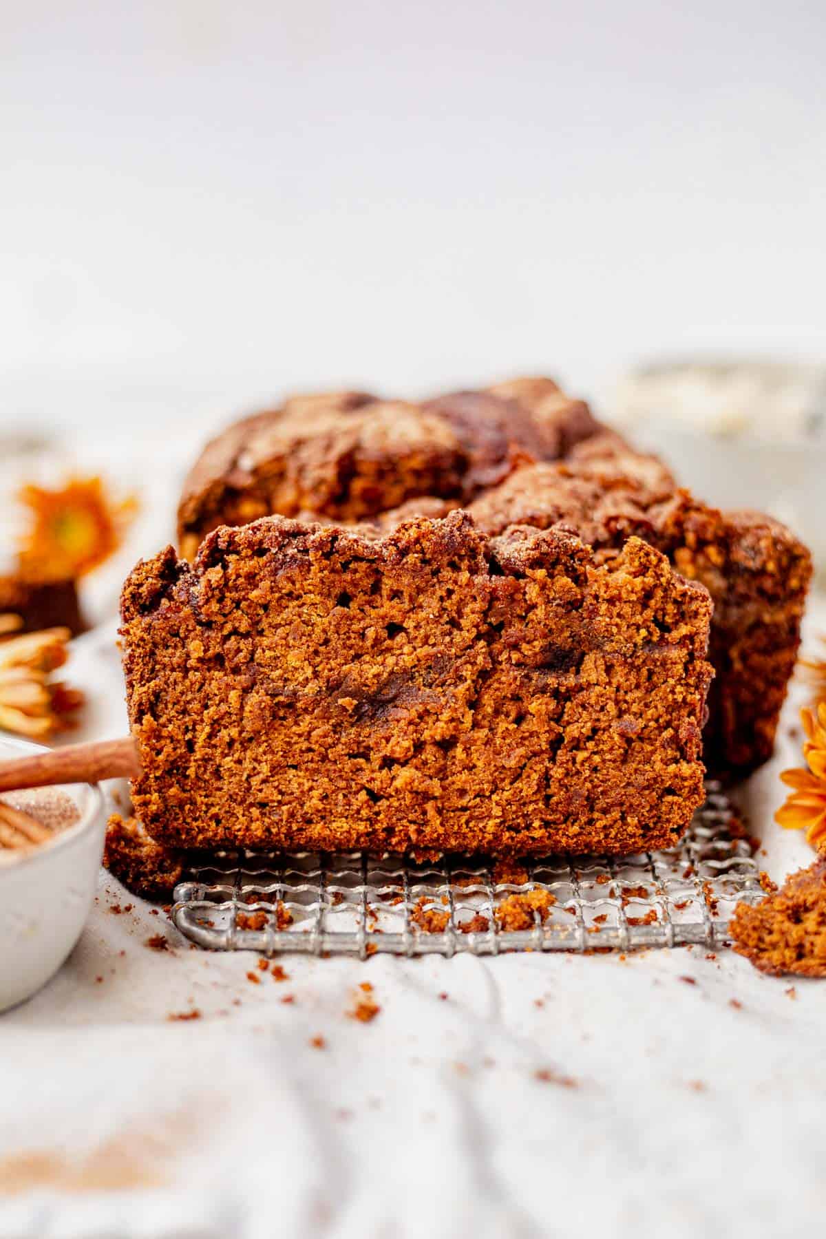 a slice of cinnamon pumpkin bread leaning against the loaf. 