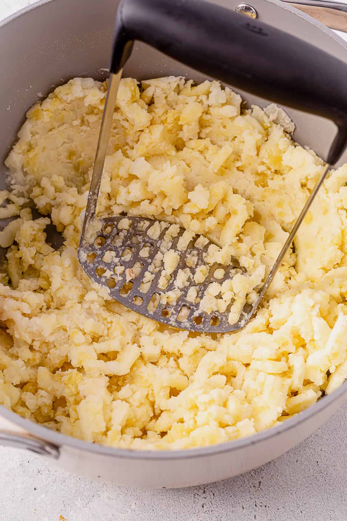 mashing potatoes with a masher