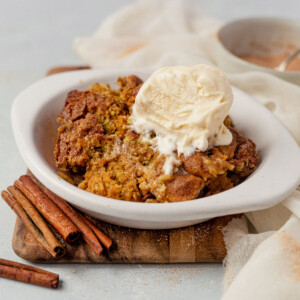 gluten free dairy free pumkpin snickerdoodle cobbler in a dish with vegan ice cream