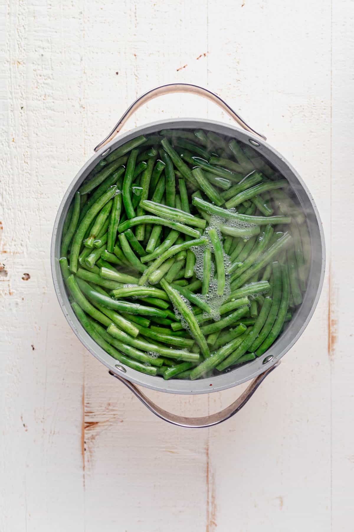 green beans boiling in a stock pot.