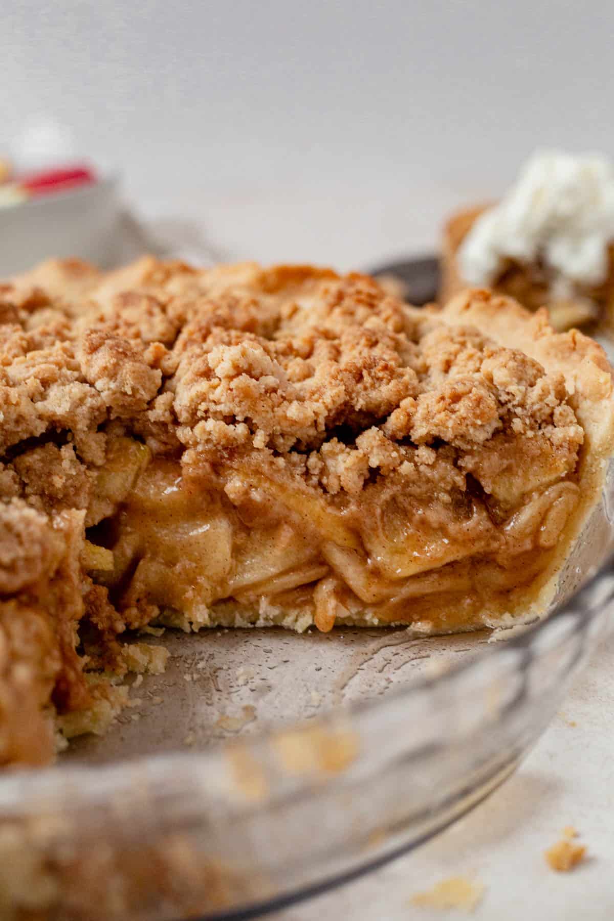 a slice of gluten free dutch apple pie missing from the pie pan.