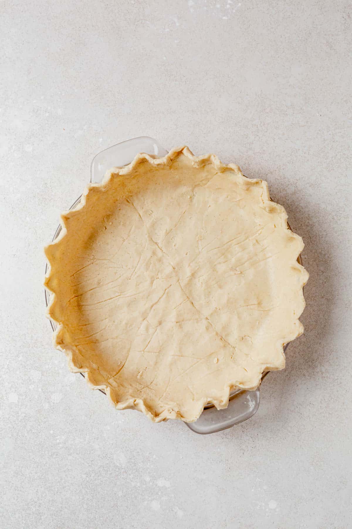 gluten free pie crust in a pie dish with fluted edges.