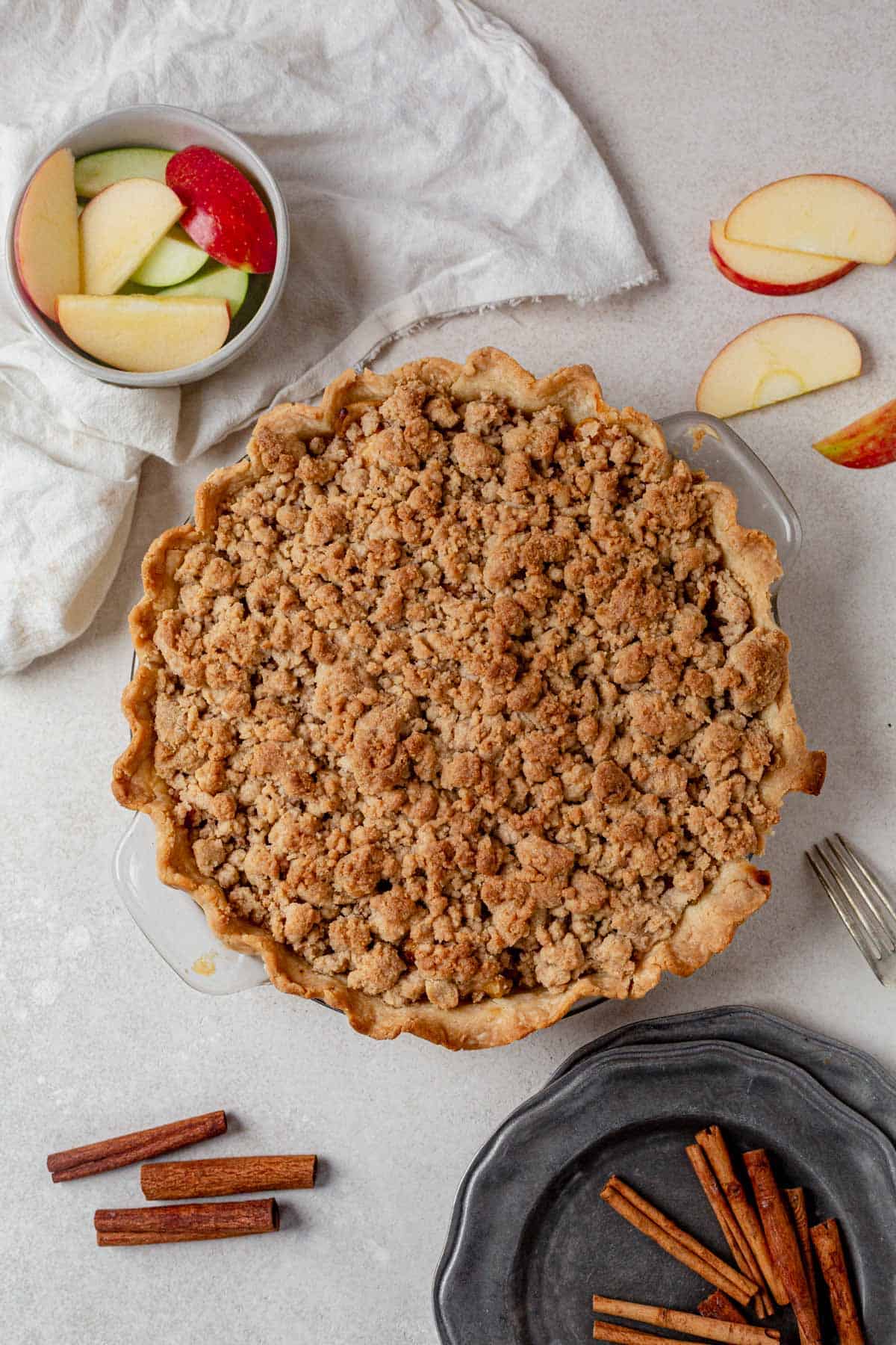 baked gluten free dutch apple pie cooling on a counter.