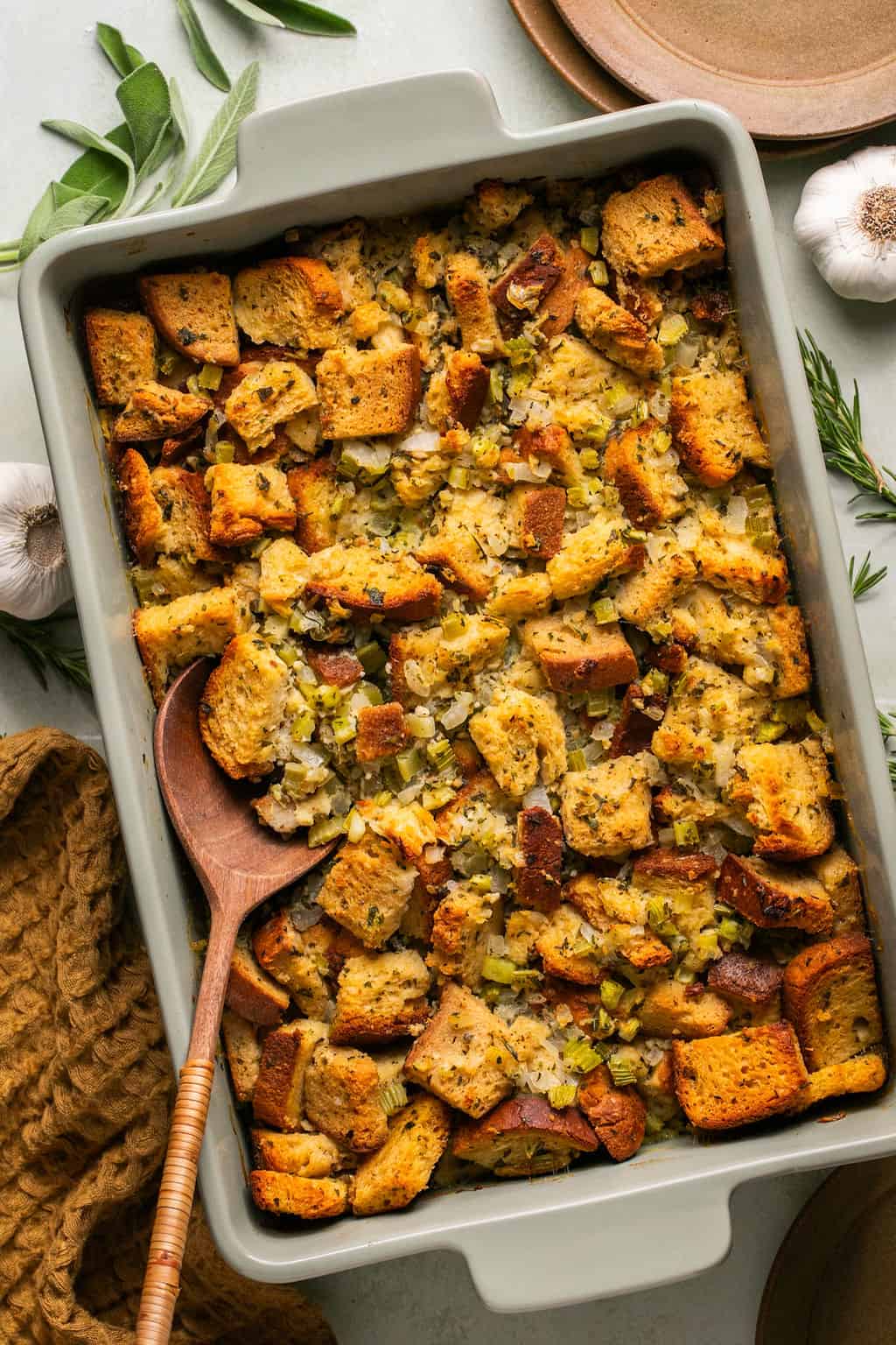 gluten free stuffing in a casserole dish with a serving spoon.