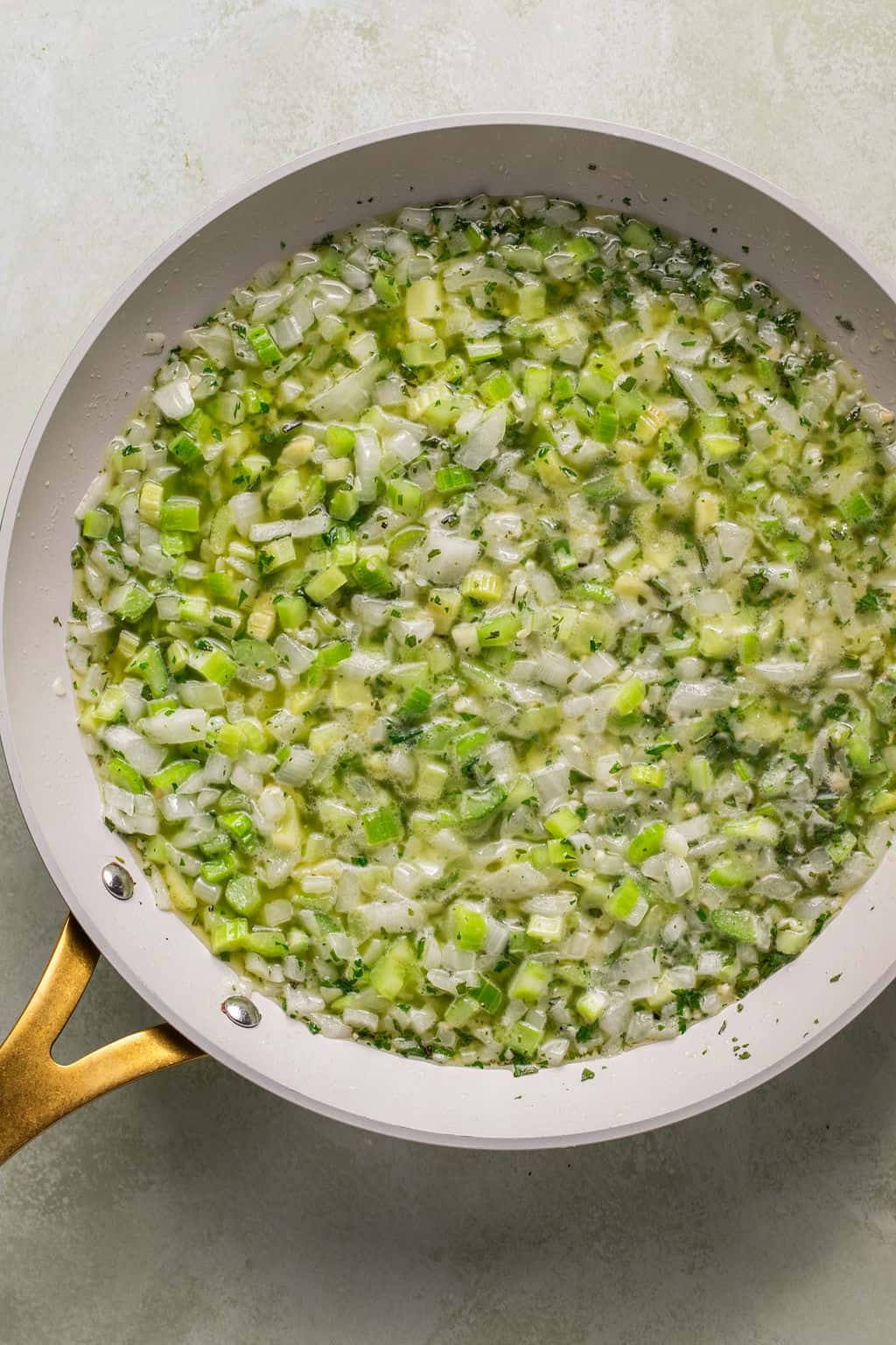 satueed celery, onion, garlic, rosemary, and sage in a skillet with butter.