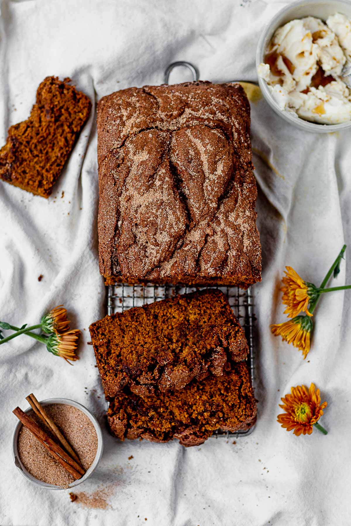 gluten-free pumpkin bread sliced next to a bowl of maple butter