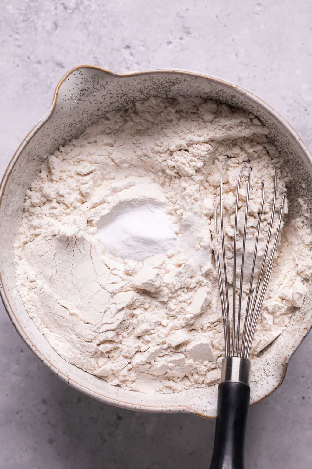 dry ingredients for cookies in a mixing bowl with whisk.