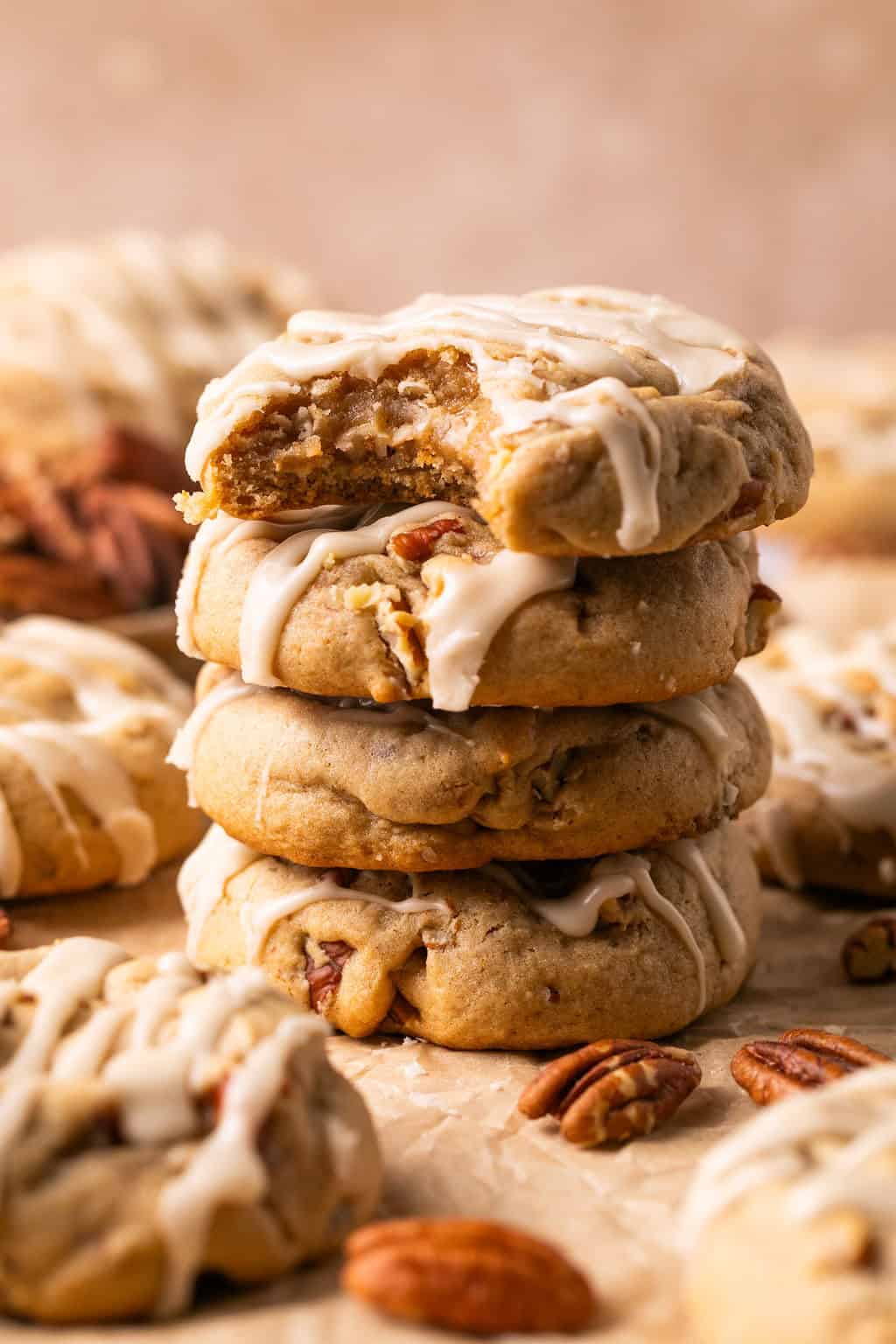 a stack of 4 maple pecan cookies topped with maple icing.