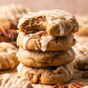 a stack of maple pecan cookies with a bite missing from the top one.