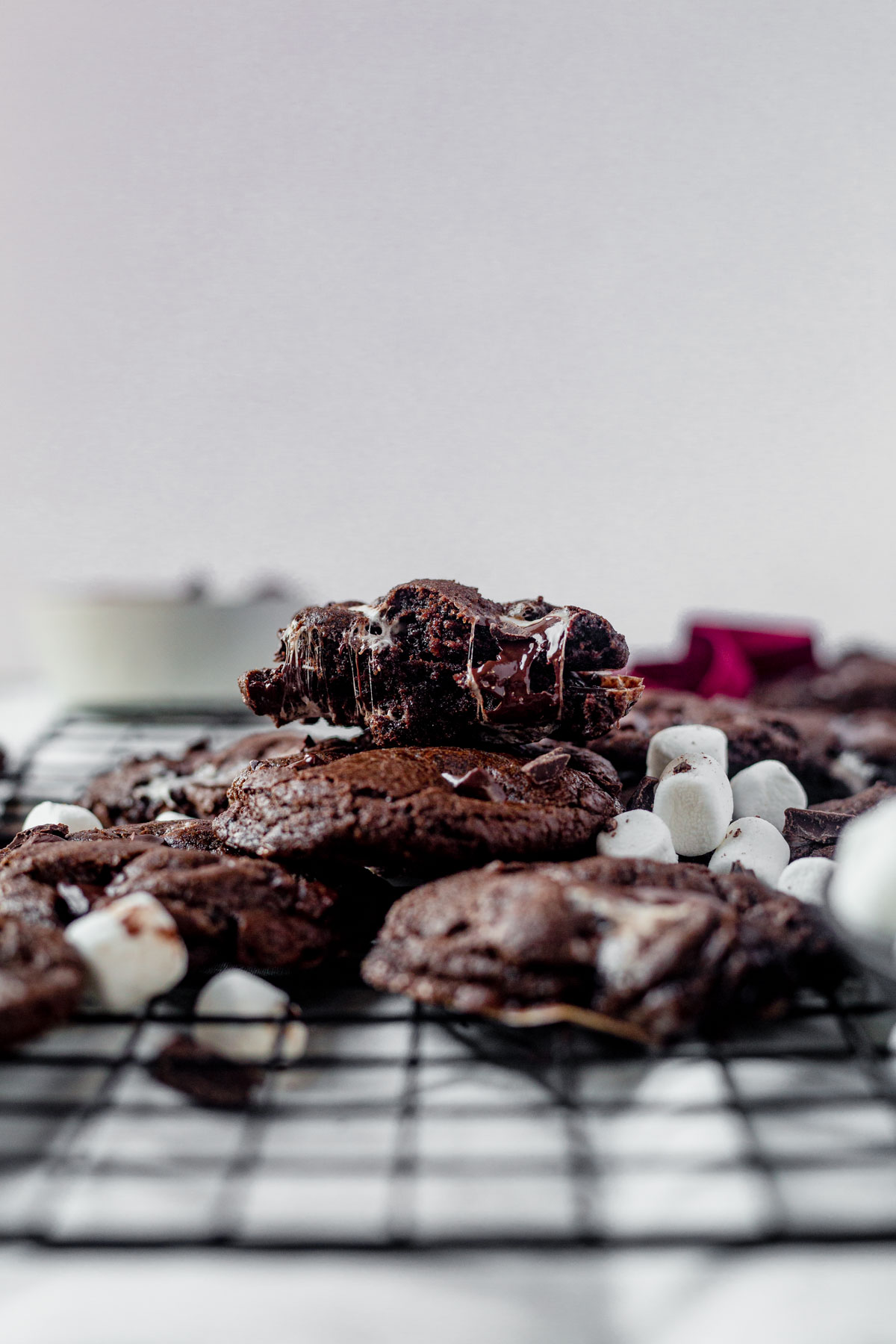 a stack of marshmallow cookies with the top one broken in half
