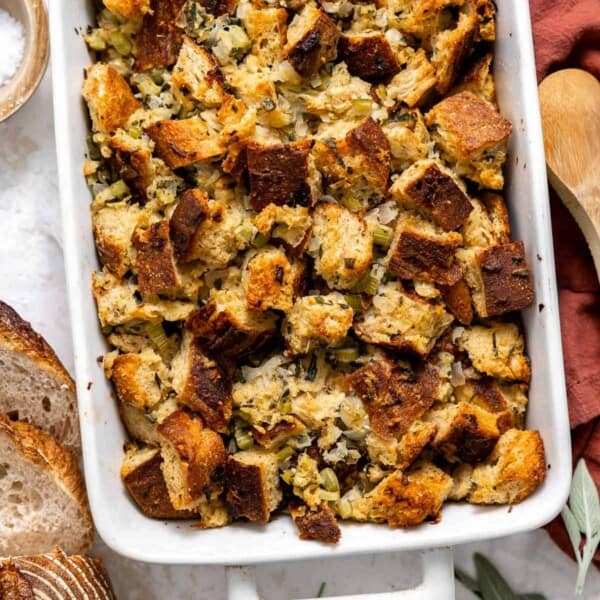 sourdough stuffing on a countertop with fresh sourdough on the side.