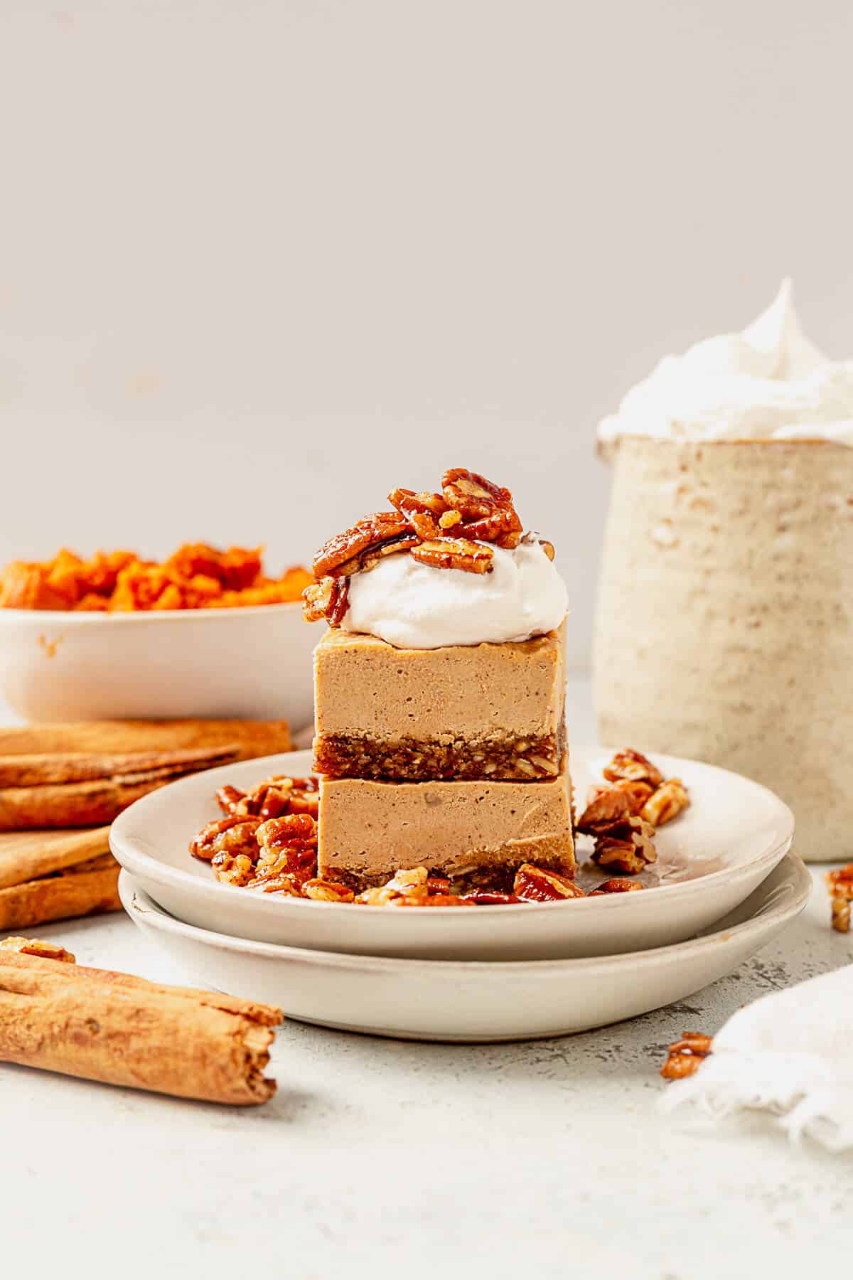 two pieces of vegan pumpkin cheesecake on a plate