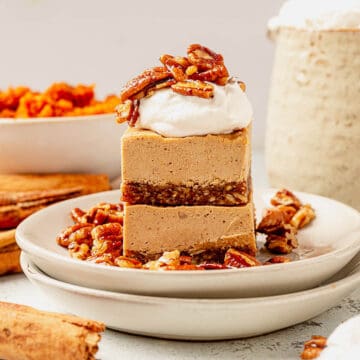 two pieces of vegan pumpkin cheesecake on a plate