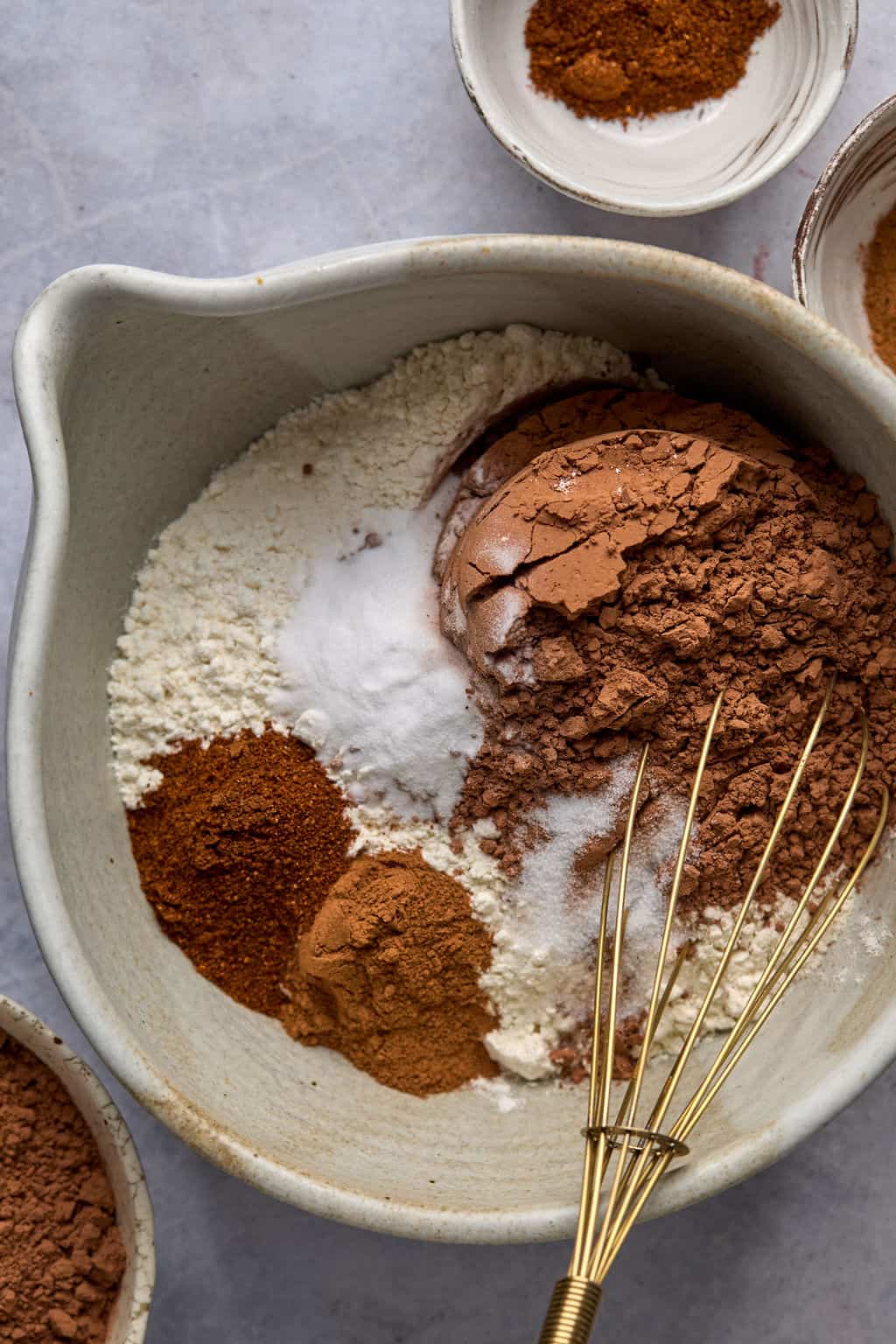 cocoa powder, chili powder, cinnamon, salt, and flower whisked in a mixing bowl.