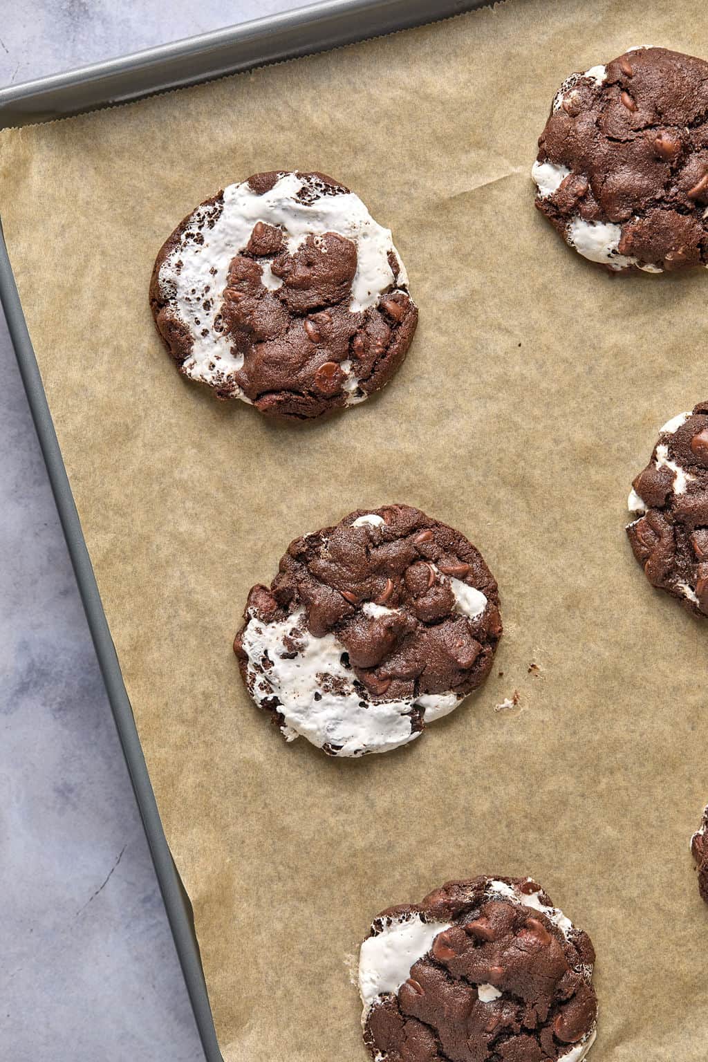 freshly baked mexican hot chocolate cookies cooling on a cookie sheet.