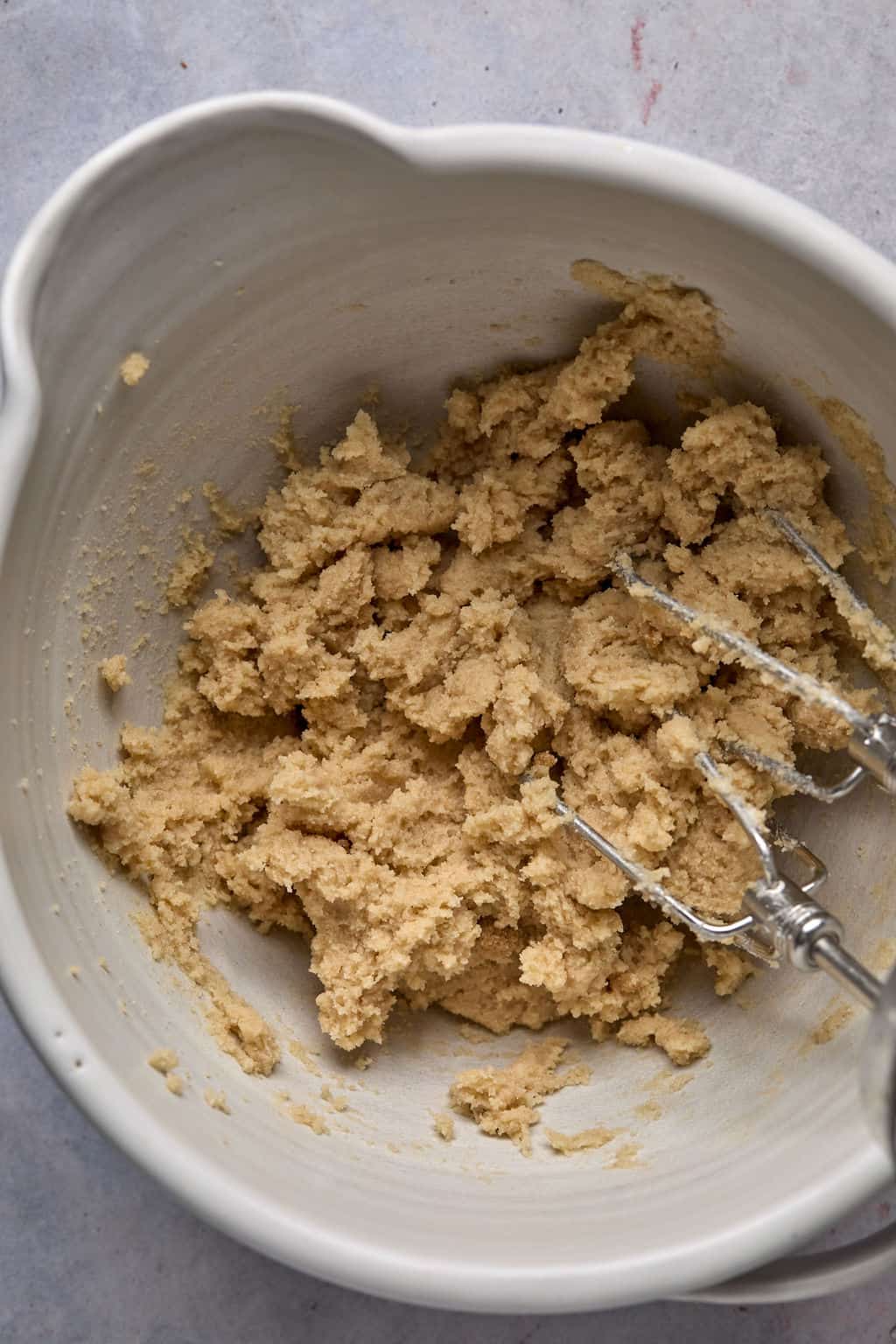 creaming butter and sugar in a bowl with an electric mixer.