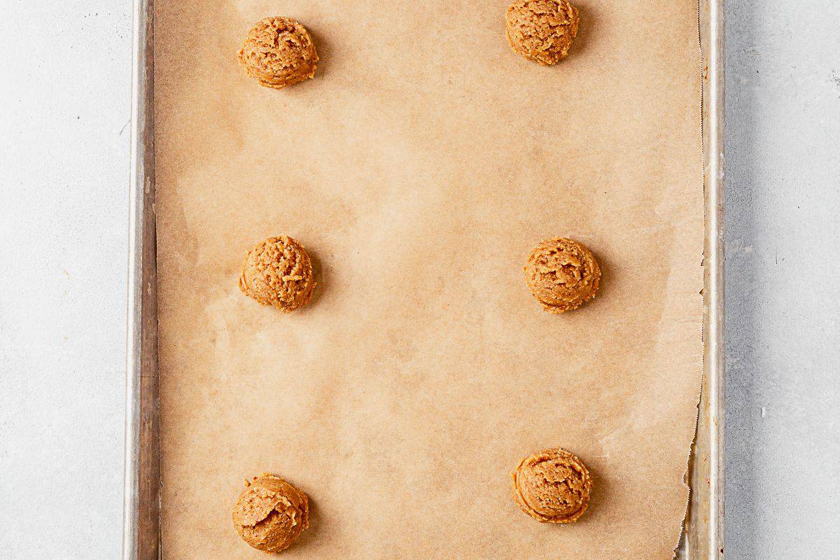 almond flour peanut butter cookie dough balls on a cookie sheet