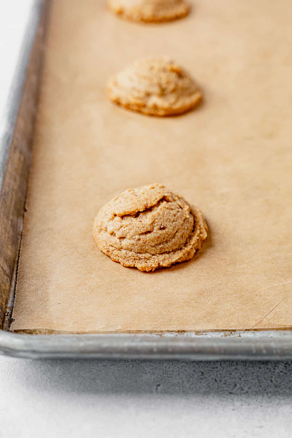 freshly baked almond flour peanut butter cookies on a parchment lined baking sheet