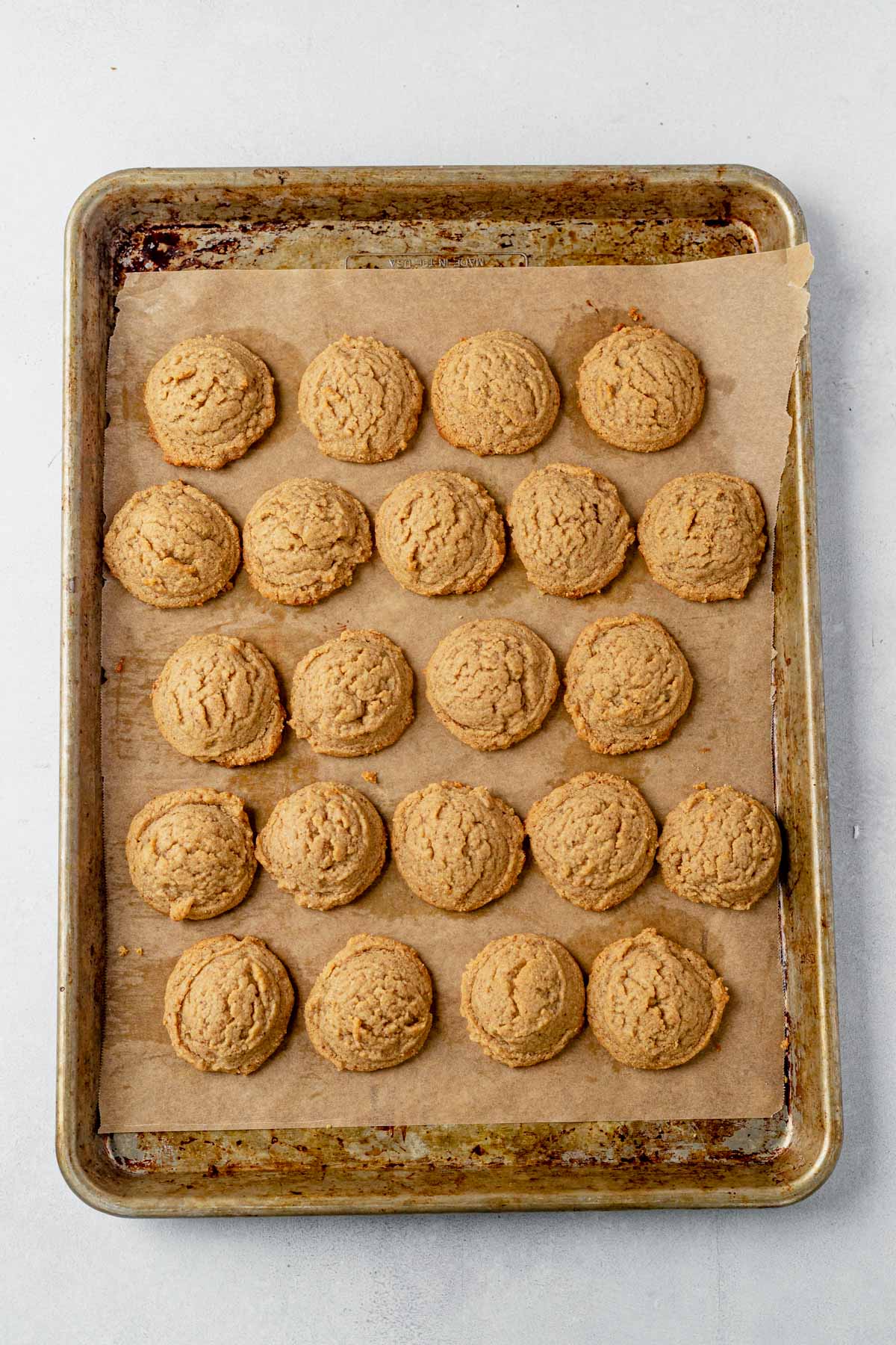 keto almond flour peanut butter cookies cooling on a baking sheet
