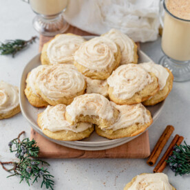 a plate of soft eggnog cookies frosted with cream cheese frosting