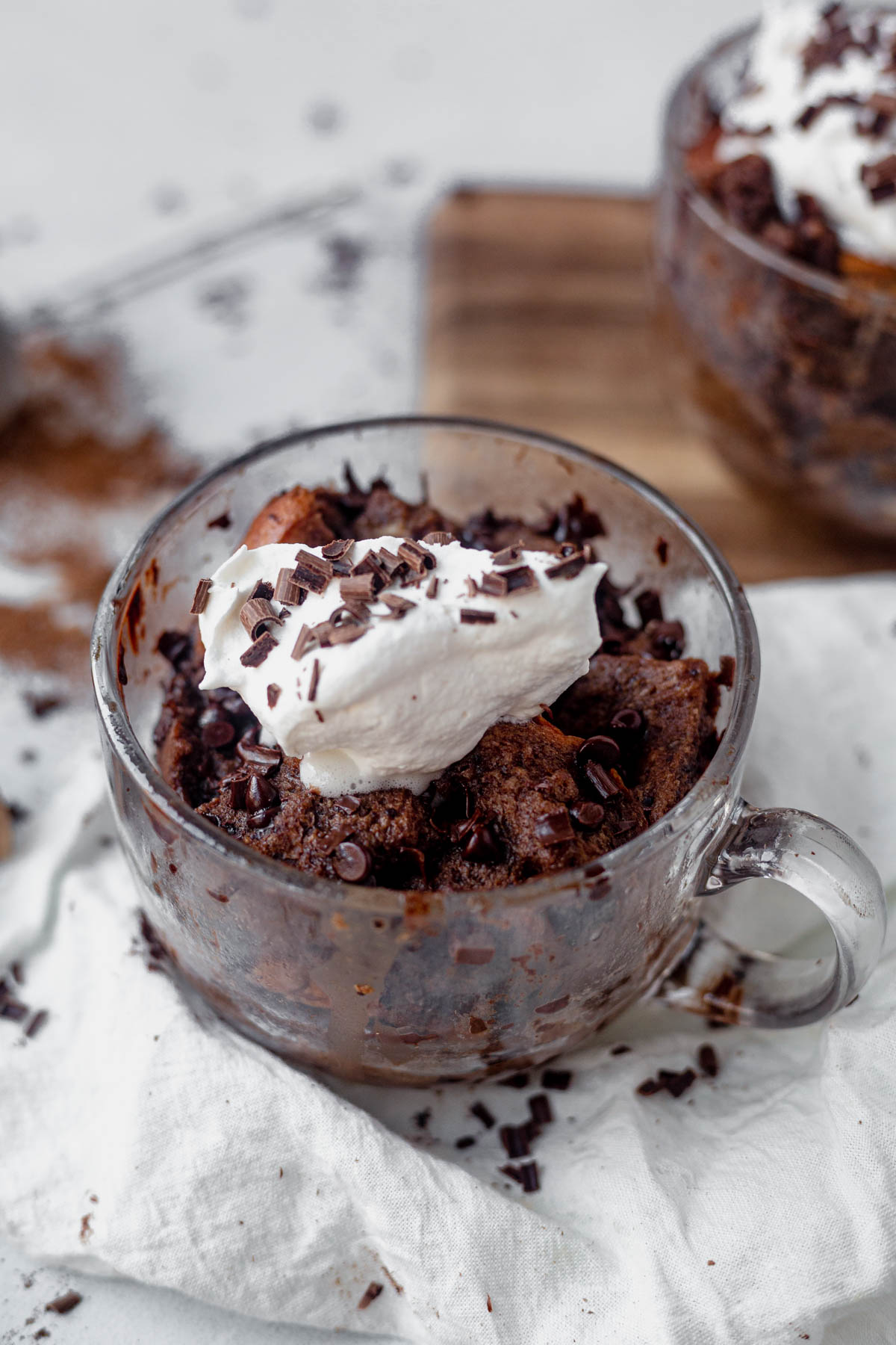 microwave bread pudding in a mug with whipped cream and chocolate