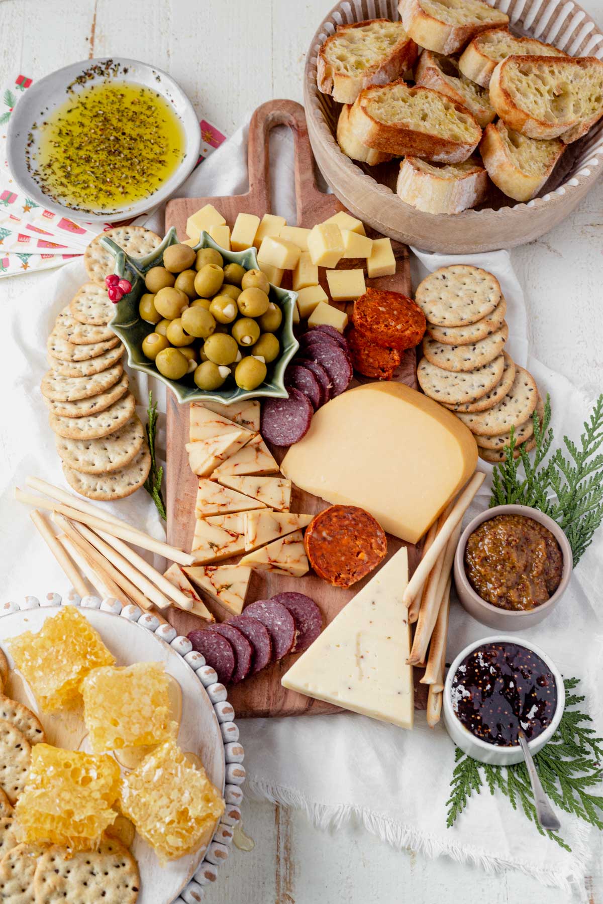 charcuterie board full of cheese, meat, bread and honey
