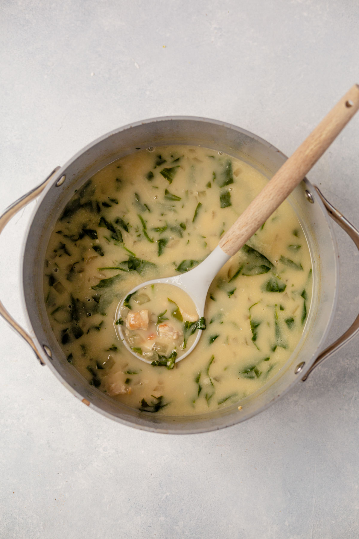a ladle scooping out chicken florentine soup