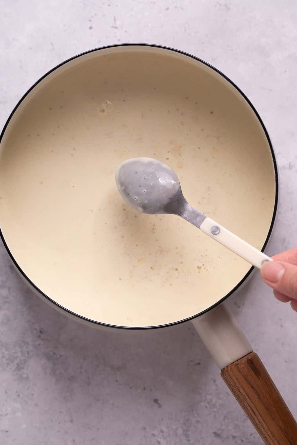 dairy-free eggnog coating the back of a spoon.