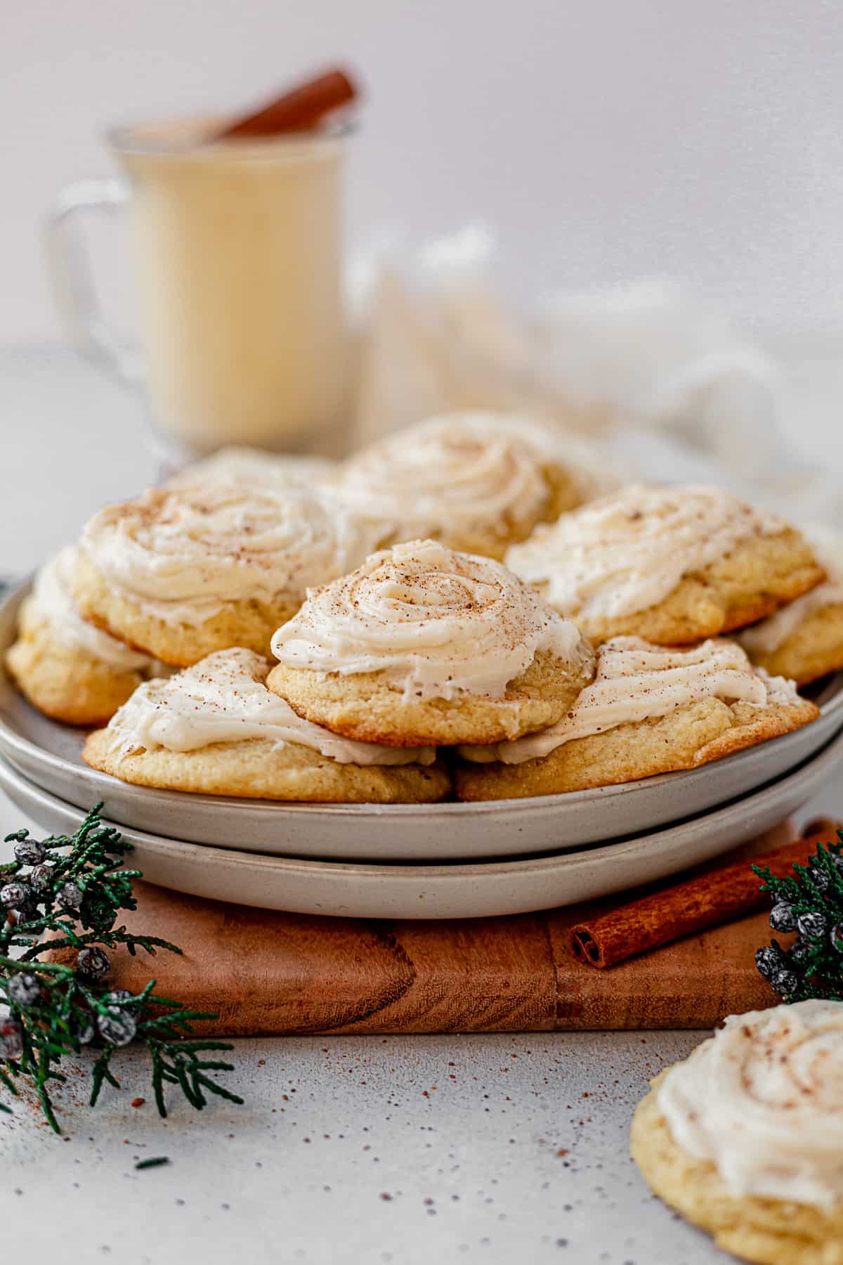 a plate of eggnog cookies with a cup of eggnog on the side