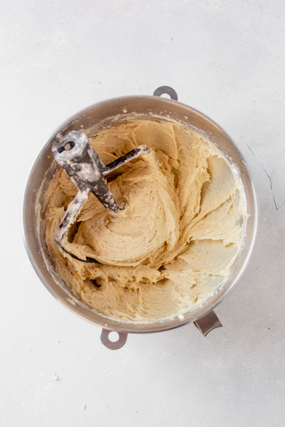 eggnog cookie batter in a mixing bowl with the paddle attachment