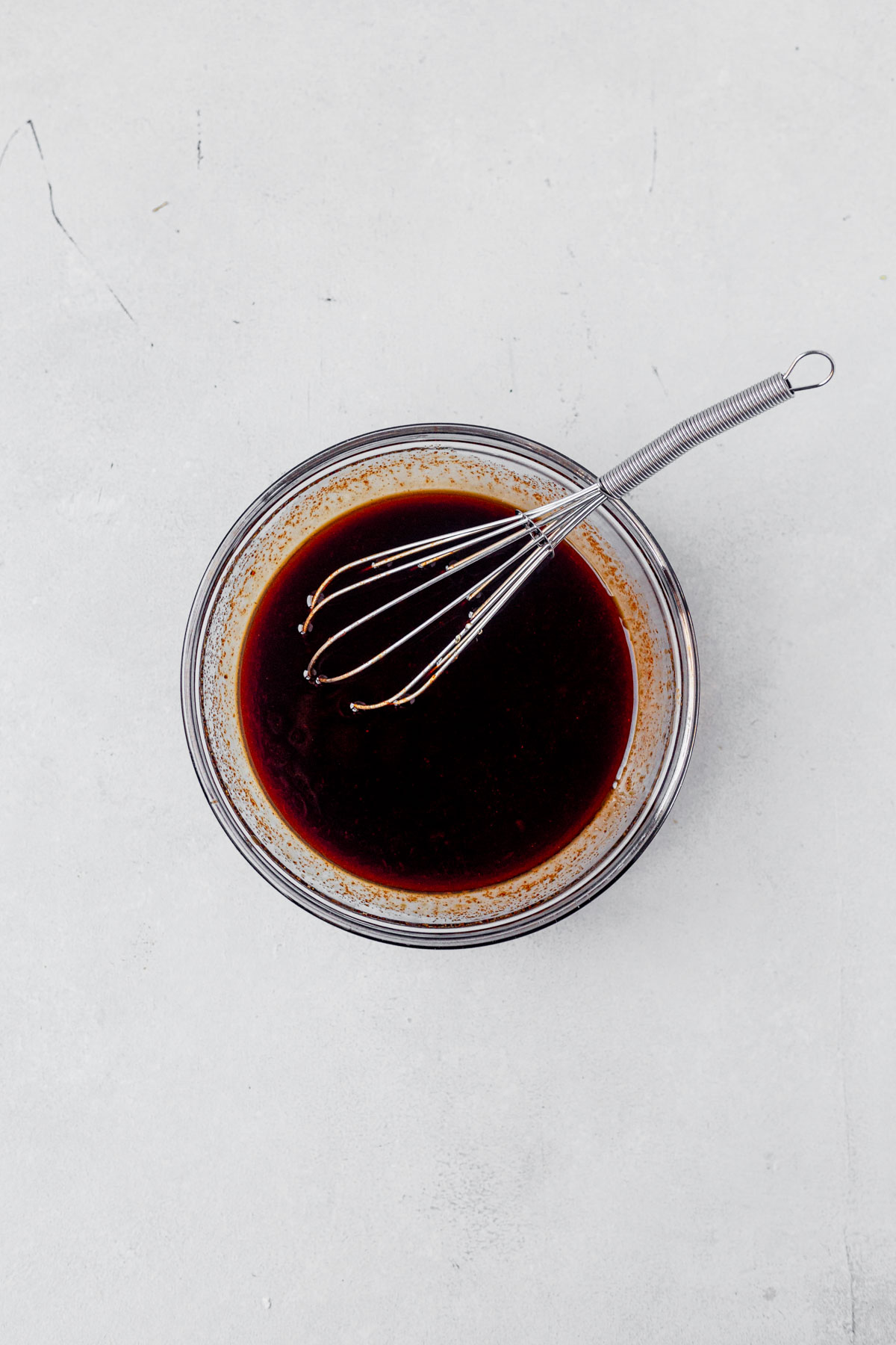 gochujang sauce with a whisk in a small bowl