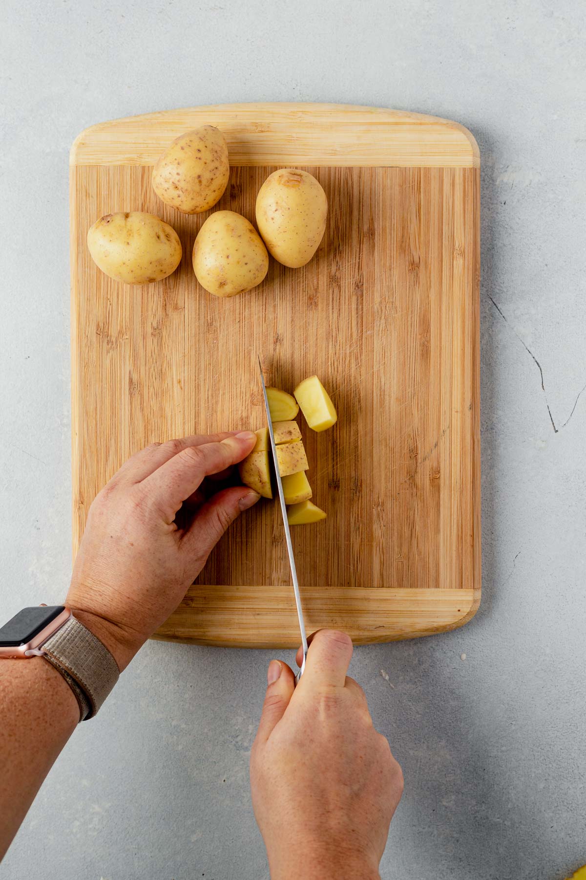 slicing a yukon gold potato for air fryer breakfast potatoes
