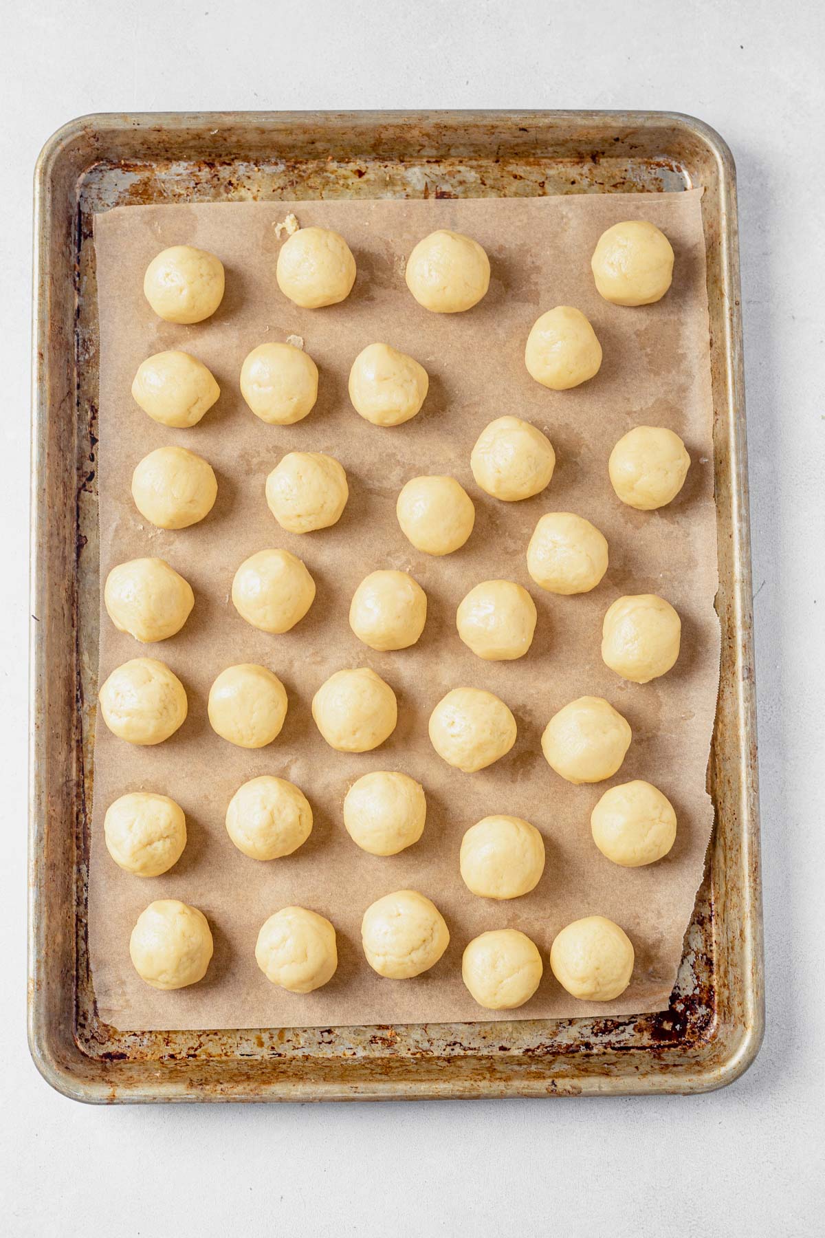 smooth rolled italian cookie dough chilled on a baking sheet