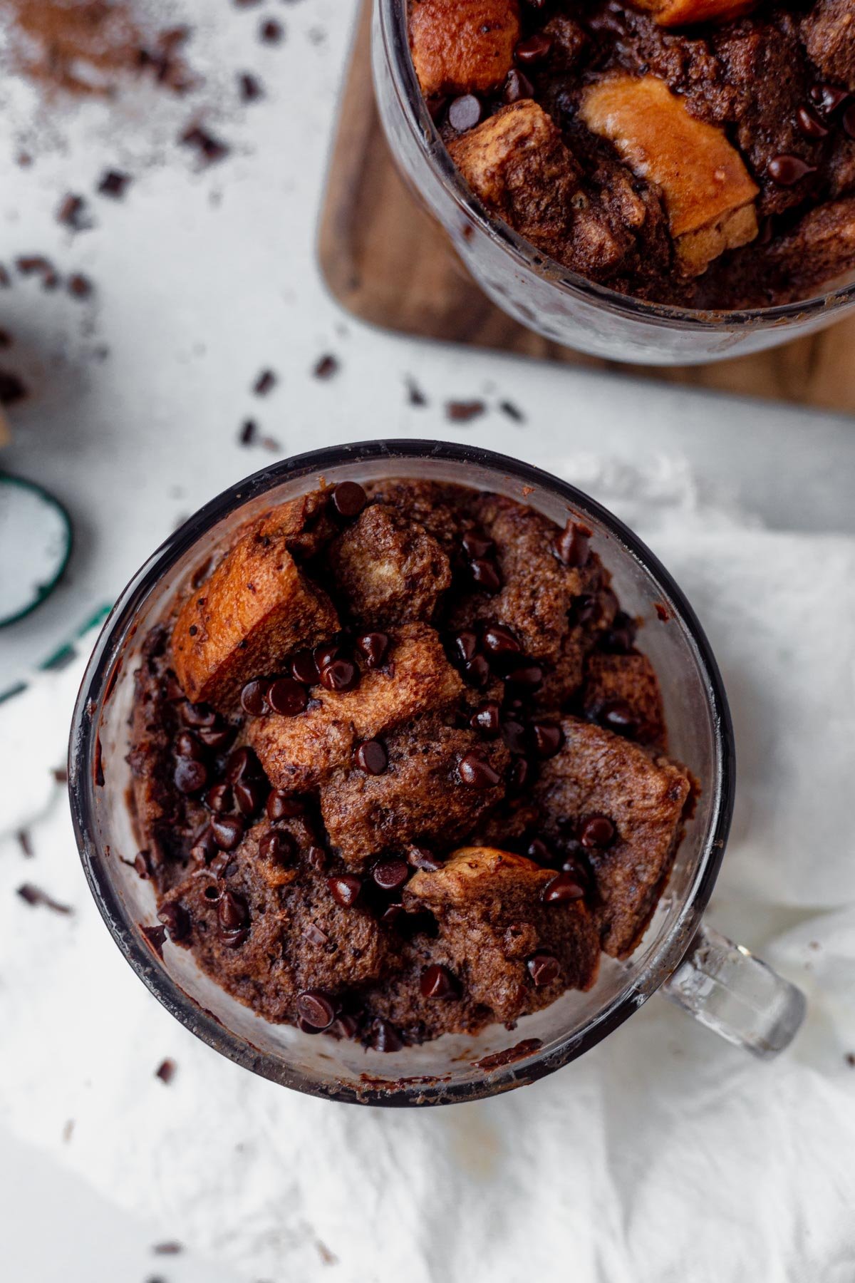 baked bread pudding in a glass mug with chocolate chips