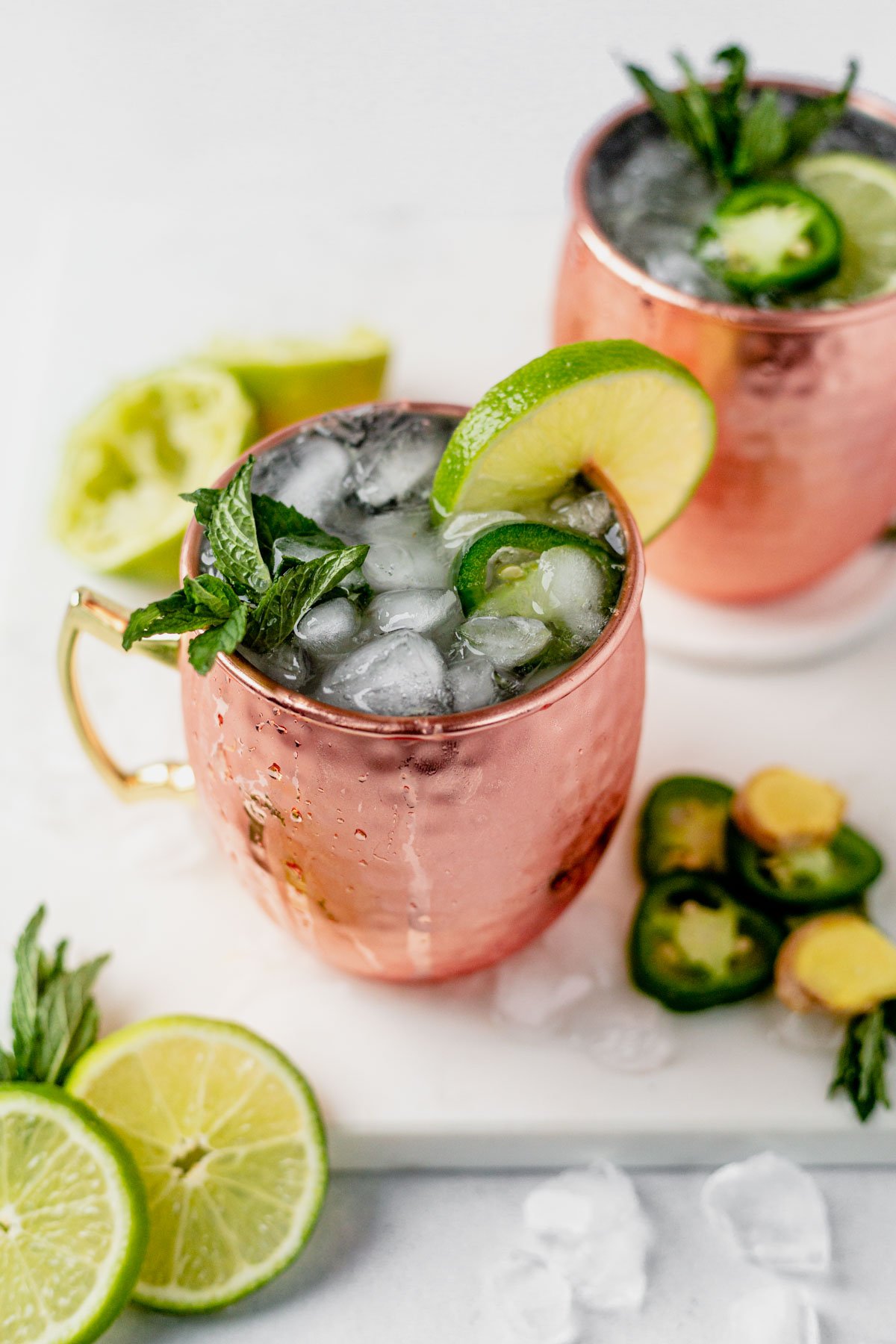 moscow mule with tequila in a copper mug with crushed ice, mint and fresh lime