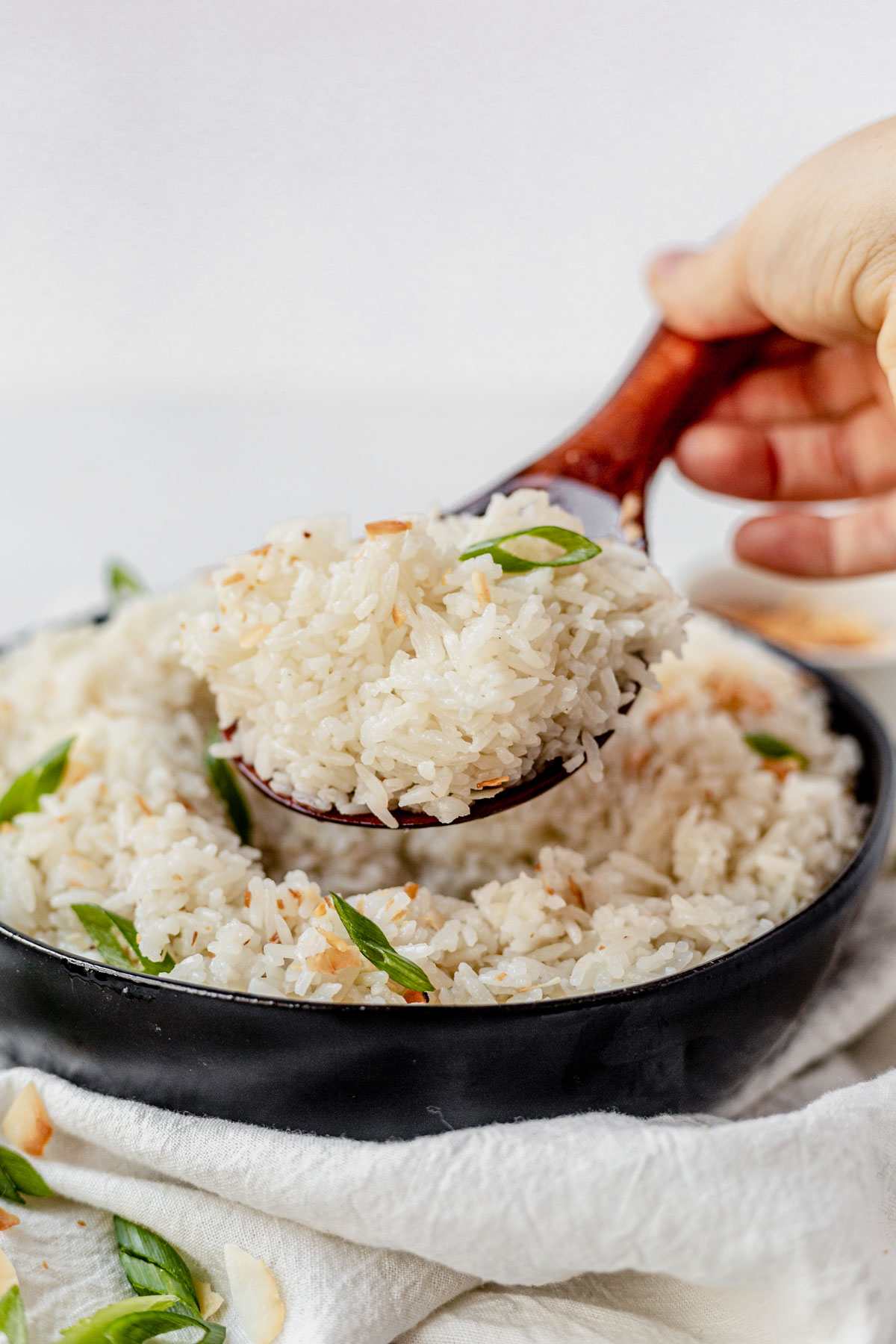 a rice spoon scooping up coconut rice