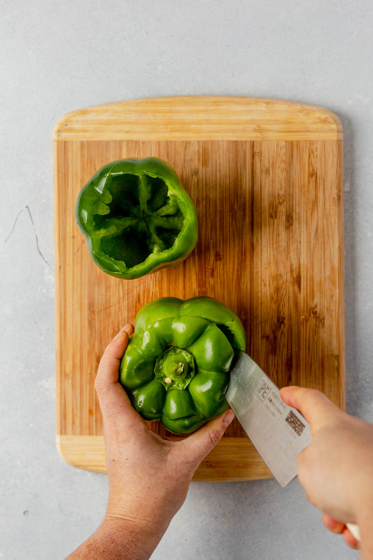 cutting around the stem of a bell pepper