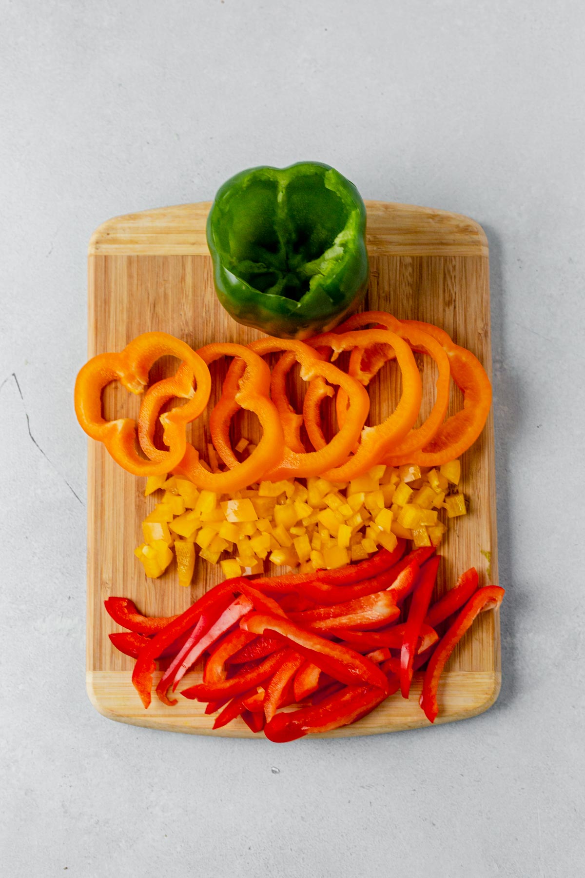 bell peppers cut four ways: sliced, diced, rings and stuffed