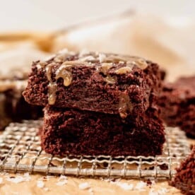 two tahini brownies on a piece of parchment paper