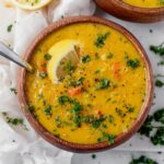 a bowl of lemon lentil soup with a spoon