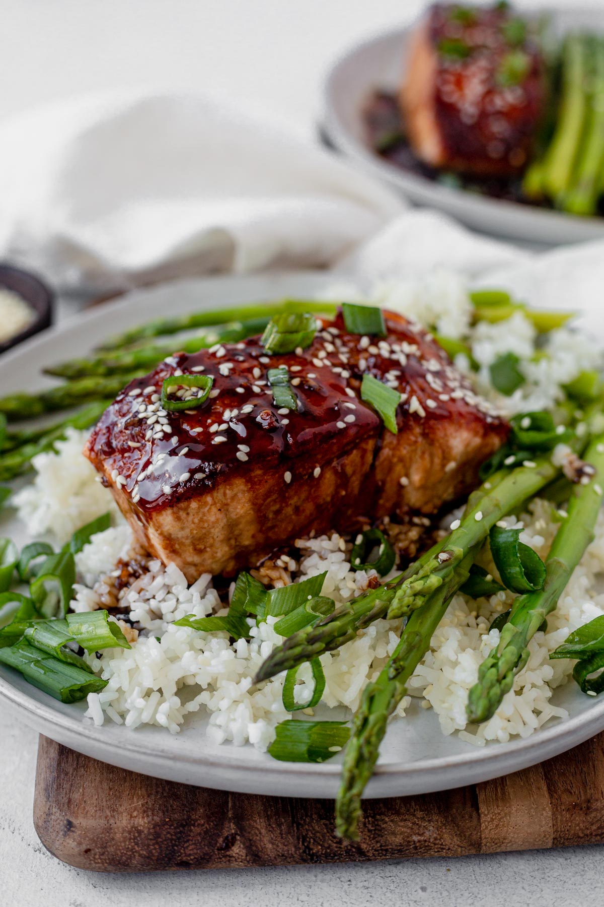 teriyaki glazed salmon on top of white rice with asparagus