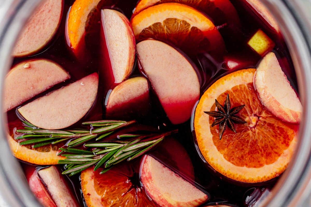fresh fruit soaking in a pitcher of winter sangria