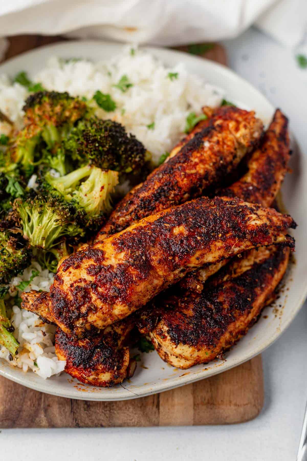 blackened chicken tenders stacked on a 