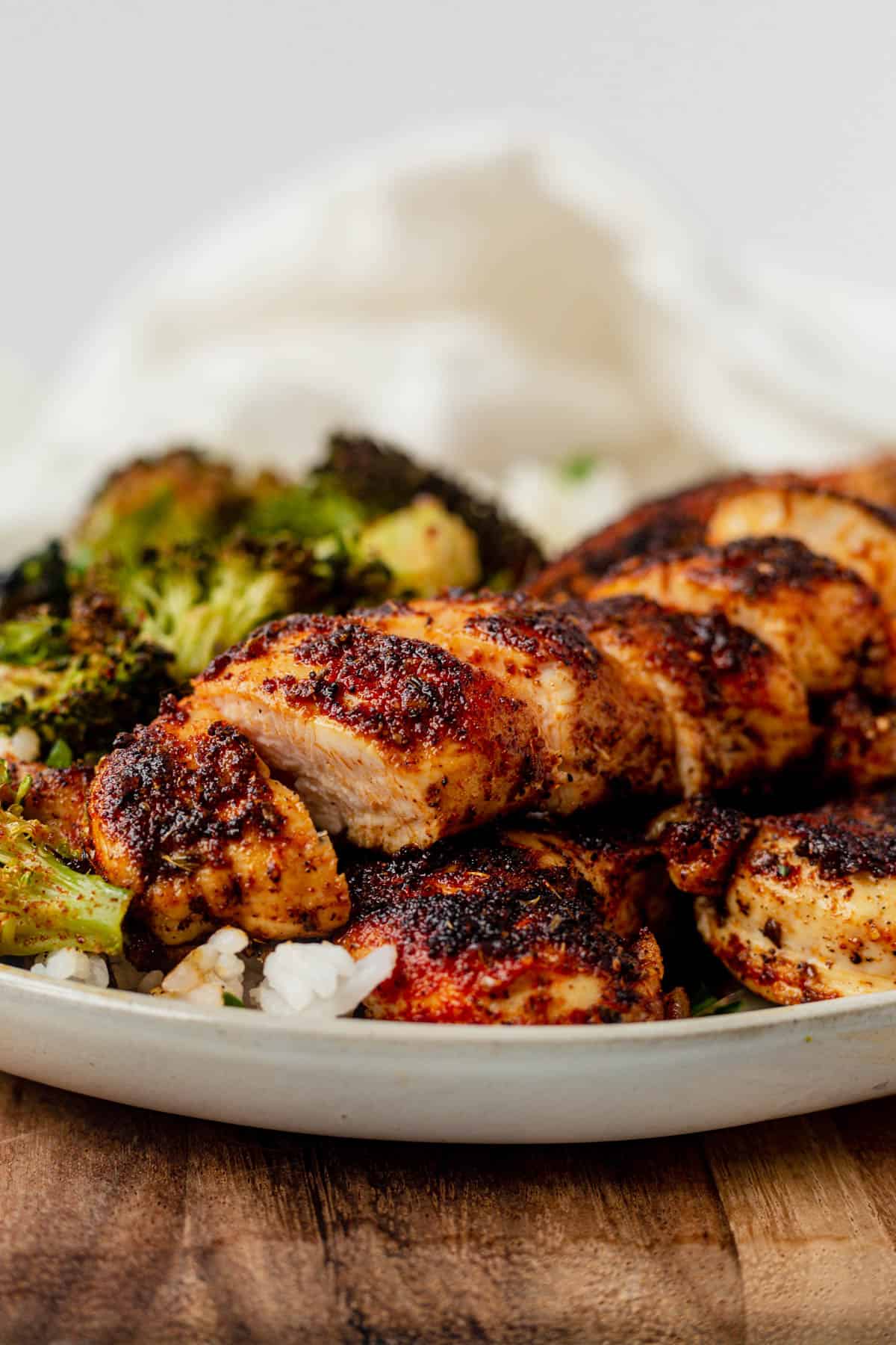 blackened chicken tenders on a plate with roasted broccoli