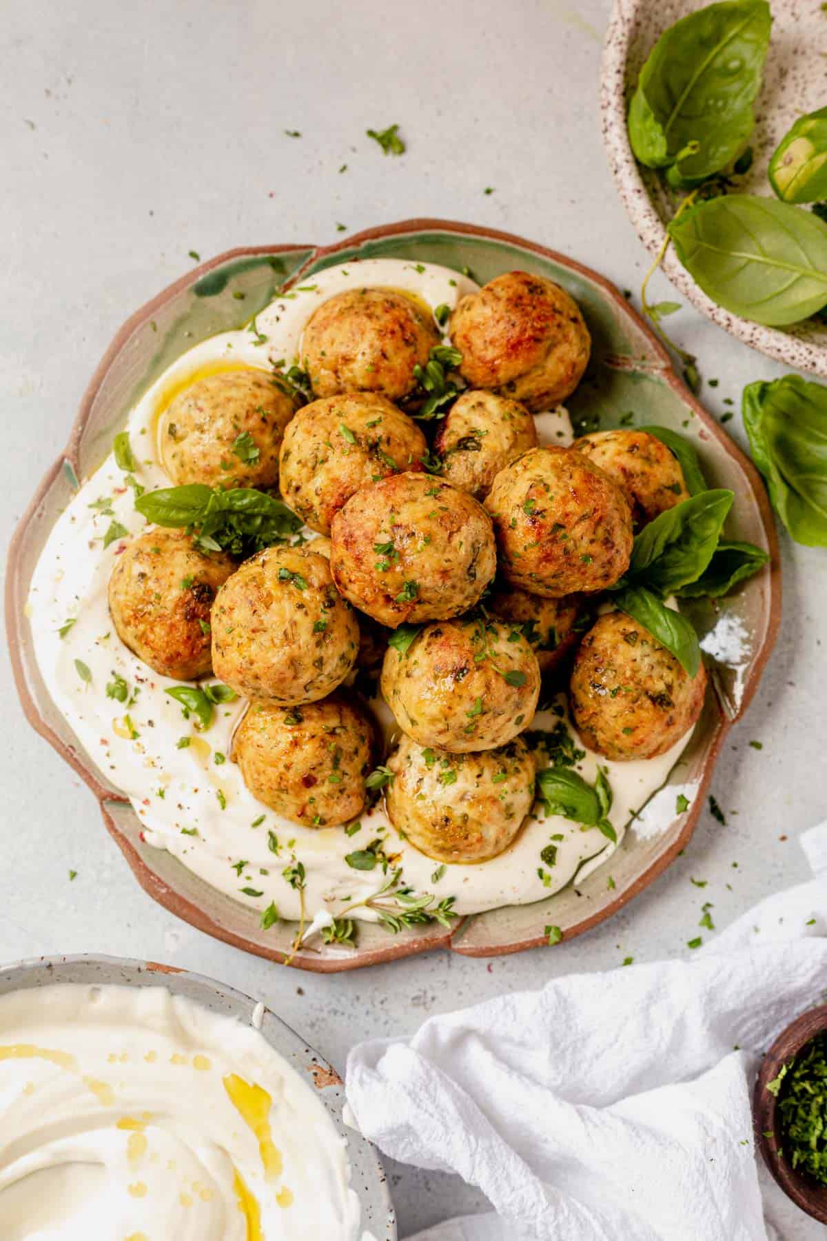 a plate of greek chicken meatballs with feta cheese